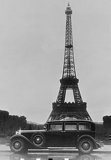 Postkartenmotiv: Anlässlich des Autosalons Paris im Jahr 1930 wird eine Limousine von Mercedes-Benz vor dem Eiffelturm abgelichtet.